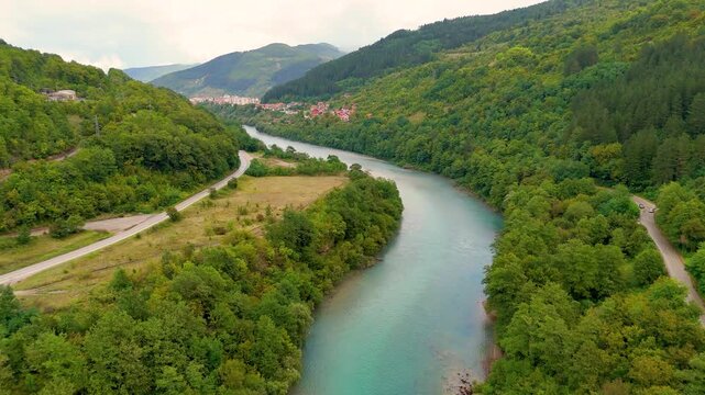 flying over the Drina river in Bosnia and Herzegovina near Brod Foca Zubovići looking over the green trees and blue water between M18 and M20 highways 