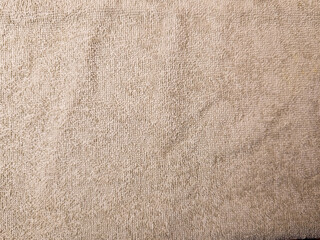 Beige cotton terry towel textured background close up