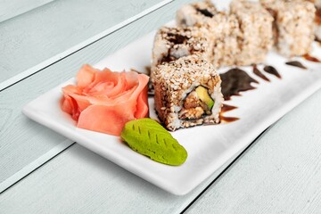 Fresh tasty sushi rolls on plate