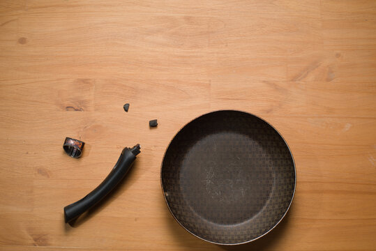 Broken Pan Handle on Wooden Table