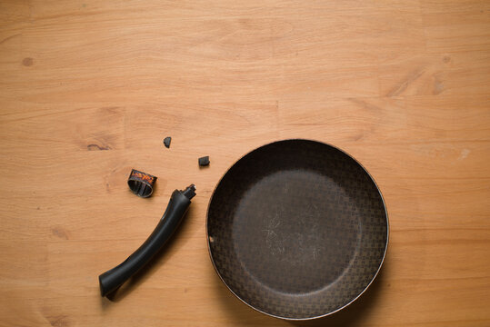 Broken Pan Handle on Wooden Table