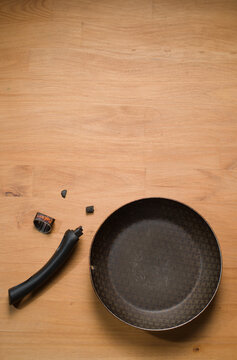 Broken Pan Handle on Wooden Table