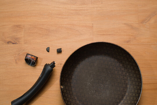 Broken Pan Handle on Wooden Table