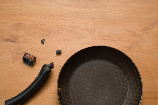 Broken Pan Handle on Wooden Table