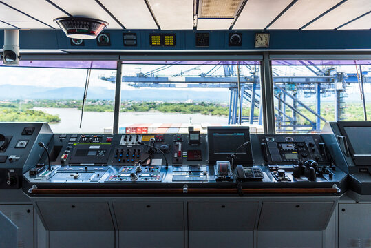 View of the control console on the navigational bridge of the cargo container ship.