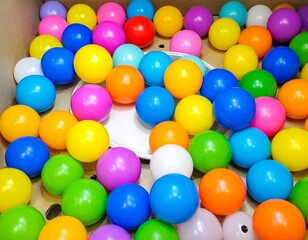 Colorful balls neatly arranged in a container. Vibrant and playful, ideal for kids&rsquo; toys, party themes, or decorative designs. Bright, fun, and visually appealing illustration