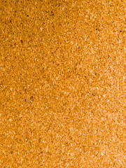 Close up of cork board texture background in warm brown color