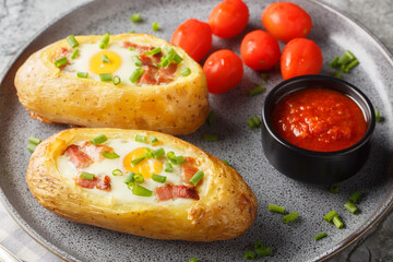 Twice Baked Potato with Egg and bacon on Top closeup on the plate on the table. Horizontal