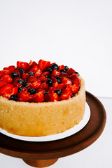 Delicious fruit cake displayed on a wooden stand for a festive celebration