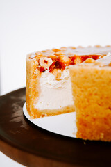 Delicious cheesecake topped with hazelnuts on a display plate