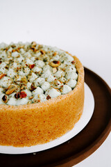 Delicious nut topped cake on a wooden serving platter ready for celebration or dessert time