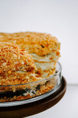 Delicious layered dessert made with crunchy topping and creamy filling in a glass dish