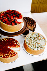 Delicious assortment of cheesecakes displayed in a dessert shop in the afternoon