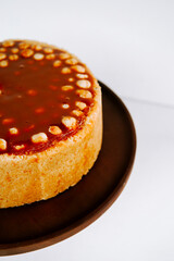 Delicious caramel dessert presented on a dark plate with a smooth surface