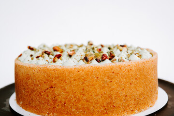 Delicious cake topped with nuts and creamy frosting in a pastry setting