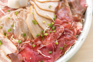 A set of raw various ingredients for mookata served on pan