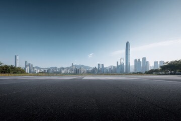 Obraz premium Urban Skyline and Empty Asphalt Road: Modern Cityscape with Copy Space, Suitable for Transportation or Business Concepts
