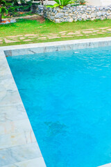 Empty swimming pool with sunbed and white umbrella in resort hotel for vacation leisure and white sand,resort neary sea and beach in summer.