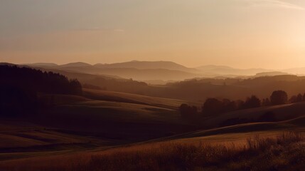 Obraz premium Sunset over rolling countryside hills