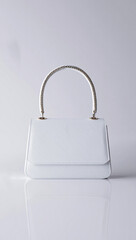 A high-angle, studio shot of a modern, white handbag.