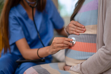 A doctor is provide in-home care to a pregnant woman.