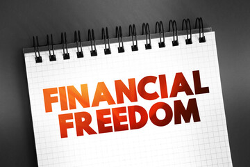 Fototapeta premium Financial freedom - having enough savings, financial investments, and cash on hand to afford the kind of life we desire for our families, text on notepad, concept background