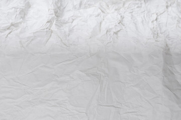 Crumpled white paper background.