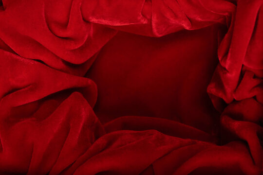 Black empty box covered with red velvet isolated on a white background.