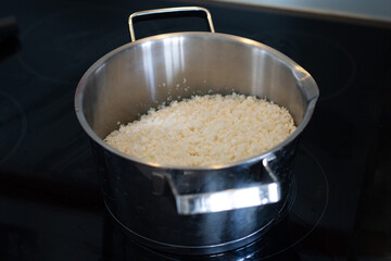 Cauliflower ground into small pieces using a blender in a steel pot.