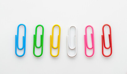 Colorful assortment of paper clips arranged on a white background