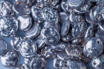 Close-up of Gleaming Metallic Silver Buttons Piled Together