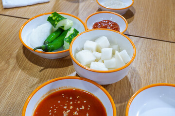 Korean side dish on wooden table in restaurant , Kimchi cabbage,radish and cucumber,Korean food homemade side dish.