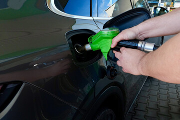 Refueling a car with gasoline at a gas station, close-up © Alina Yermakova
