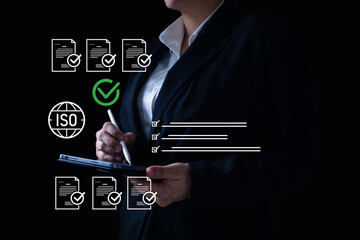 Quality assurance and ISO compliance concept as businesswoman uses digital checklist on tablet with stylus, representing certified standards, auditing, and document control in modern business.