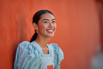 friendly filipina woman dressed in traditional attire smiles warmly against clean solid background
