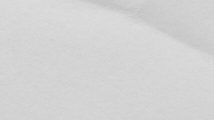 Close up of a crumpled piece of white paper showing texture and subtle shadows across the surface - Powered by Adobe