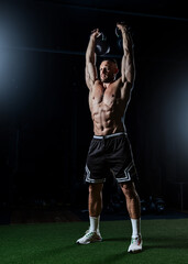 Muscular man having training with weights. Strong athletic man does workout. Concept bodybuilder doing exercises in gym.