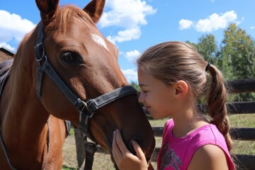 Obraz premium Girl Petting Horse. Equestrian Summer Camp Outdoors with Horses
