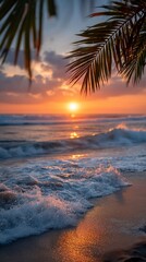 Sunset over ocean with palm leaves waves and beach.
