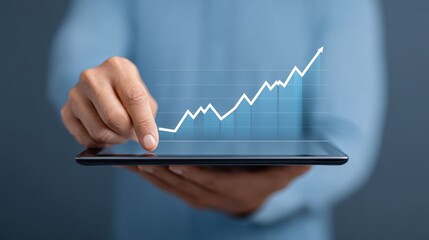 Business professional analyzing growth trends on digital tablet with upward chart in modern office setting for financial success and data analytics