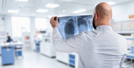 Fototapeta premium Senior doctor hold xray for thinking in clinic