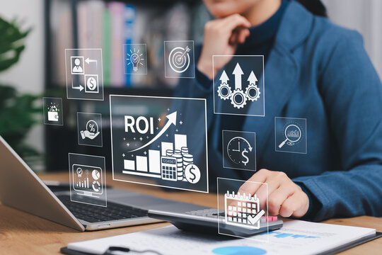 Analyzing ROI and Business Strategy Concepts. Businesswoman working on laptop with icons representing ROI, financial strategies, return on investment, and efficiency. calculate profit, marketing plan,
