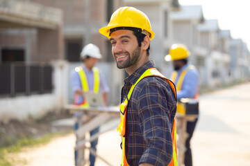 Portrait Hispanic male engineer : Architect, contractor and architecture standing in house building under construction site. Engineering in safety harthat helmet, Professional engineering teamwork