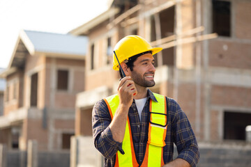 Portrait Hispanic male engineer : Architect, contractor and architecture standing in house building under construction site. Engineering in safety harthat helmet, Professional engineering teamwork
