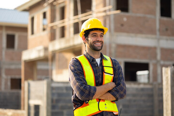 Portrait Hispanic male engineer : Architect, contractor and architecture standing in house building under construction site. Engineering in safety harthat helmet, Professional engineering teamwork
