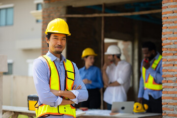Portrait of Japanese Site Manager :  Architect and contractor worker planning and architecture in Residential Building Construction site. Engineering in safety harthat helmet. Engineering team