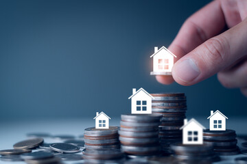 Real estate property investment concept, stacking coins and model house increasing, invest real...