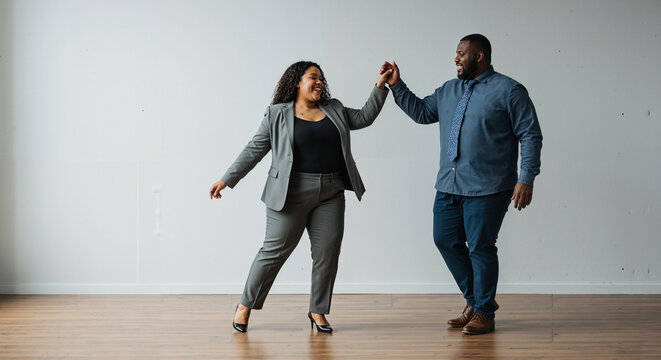 Young black couple dancing together in modern studio space  