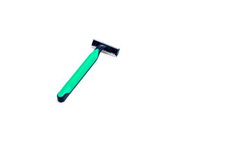Close-up shot of a green disposable razor, providing a clear view on a white background