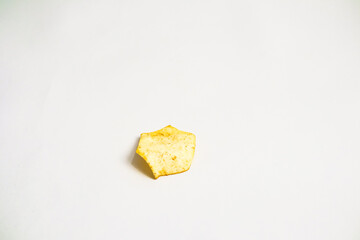 A single, crispy potato chip isolated on a clean white background conveys simplicity